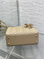 Dior quilted mini handbag with top clasp and short handle strap in beige