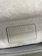 Dior brand label on quilted handbag reading “Christian Dior” and “Made in Italy”