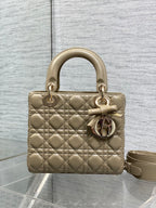 Dior quilted mini handbag in beige with bow charm, gold hardware, and shoulder strap