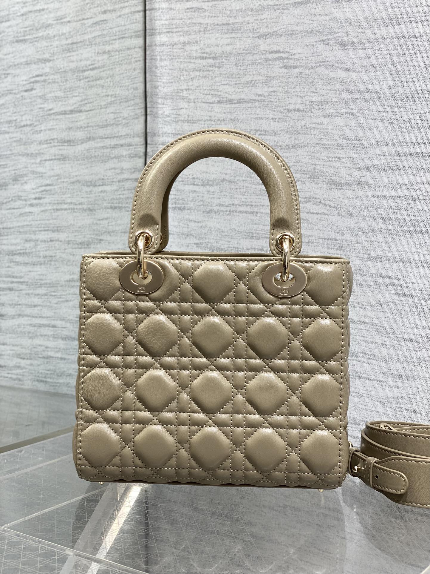 Dior quilted mini handbag in beige with top handle and long crossbody strap