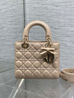 Dior quilted beige handbag with short top handles, bow detail, and crossbody strap