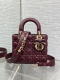Burgundy quilted top-handle mini bag with gold-tone hardware and shoulder strap