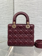 Burgundy quilted top-handle mini bag with gold-tone rings and side shoulder strap