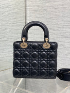 Black quilted mini handbag with double top handles and gold-tone hardware