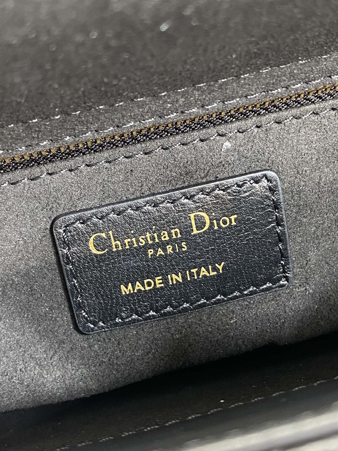 Close-up of interior label: Christian Dior Paris, Made in Italy on gray lining