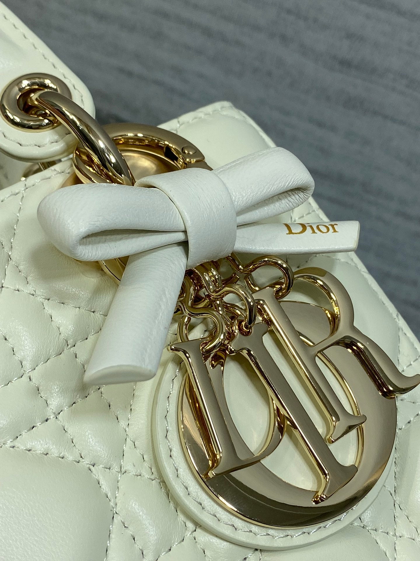 White leather handbag bow with gold-tone Dior charm and gold hardware