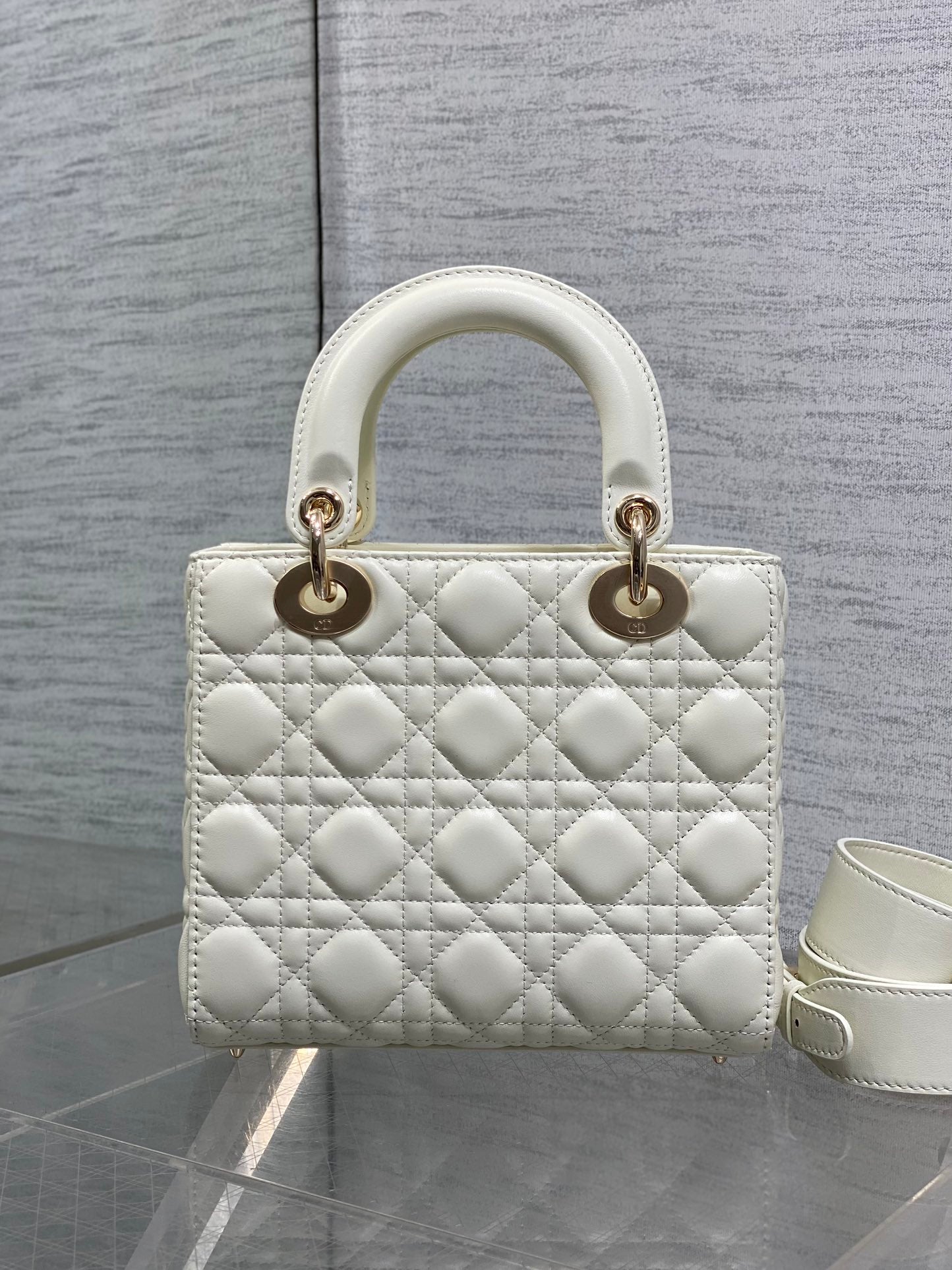 White quilted handbag with two top handles and gold-tone hardware