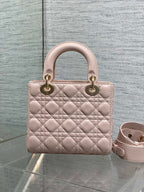 Light pink quilted mini handbag with rounded handles and adjustable crossbody strap