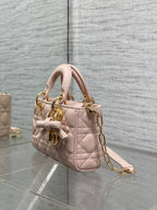 Dior bag side view in pale pink quilted leather with gold chain strap