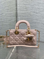 Dior bag in pale pink quilted leather with top handles, bow detail, and gold chain strap