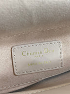 Dior bag label on pale pink leather reading “Christian Dior PARIS”