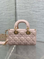 Dior bag in pale pink quilted leather with top handles, bow detail, and gold chain strap