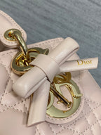 Dior bag bow and gold clasp detail on pale pink quilted leather