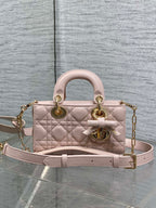 Dior bag in pale pink quilted leather with top handles, bow detail, and gold chain strap