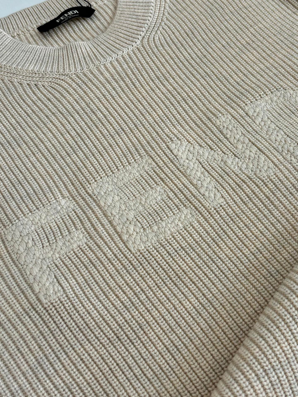 Cream knit sweater with textured diamond pattern detail