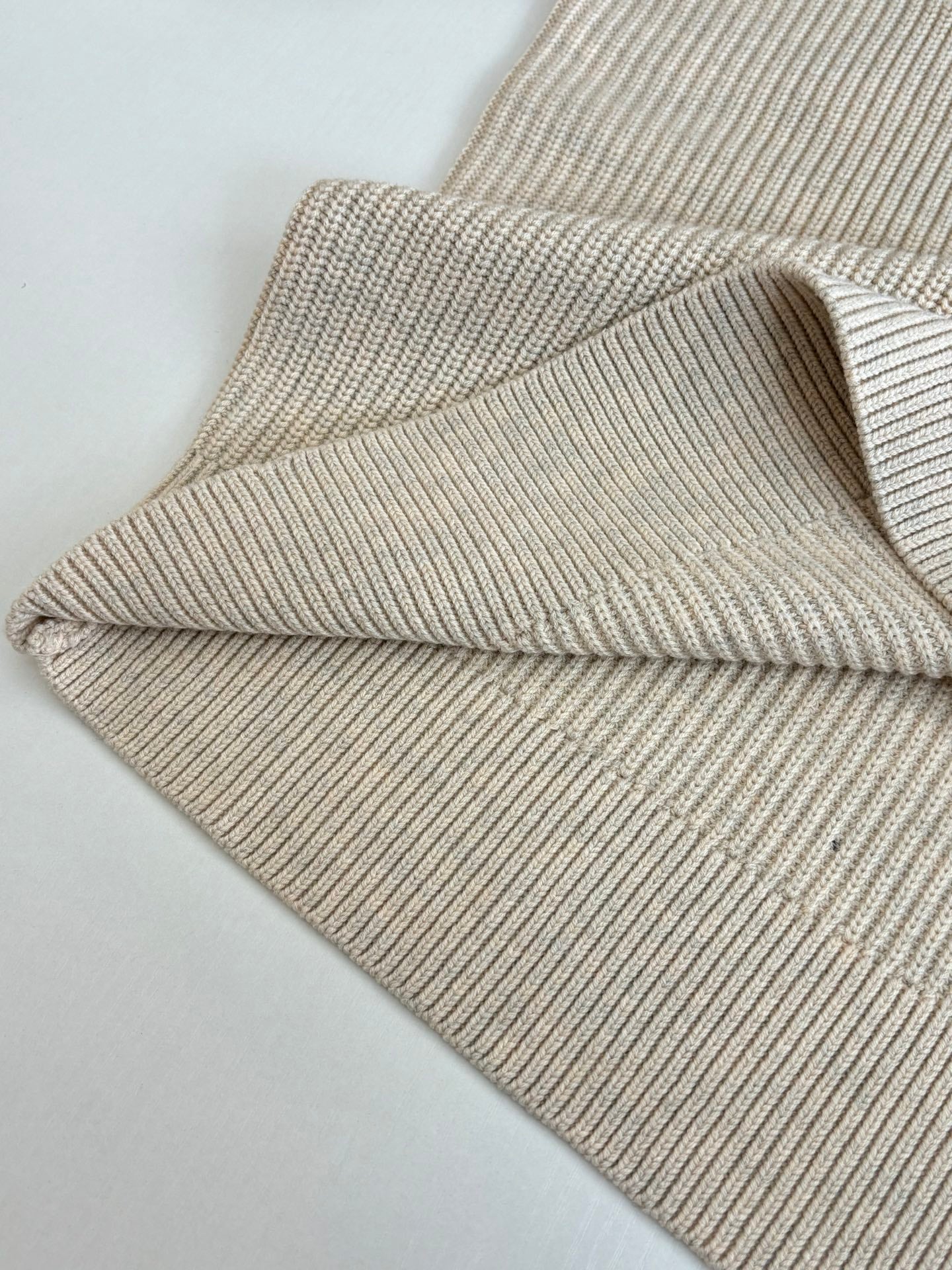 Cream knit sweater sleeve and ribbed cuff detail, long sleeve