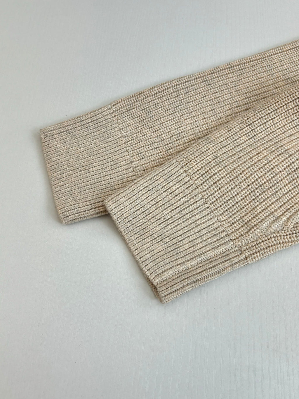 Cream ribbed knit sweater cuff and hem detail