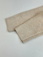 Cream ribbed knit sweater cuff and hem detail
