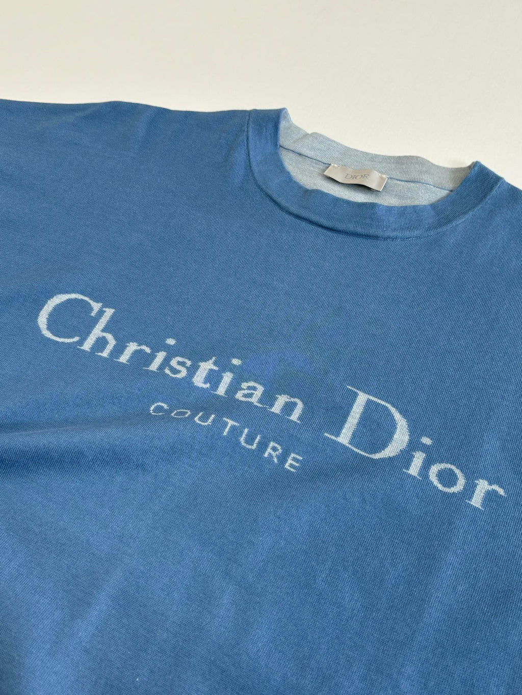 Blue Christian Dior logo T-shirt chest print close-up