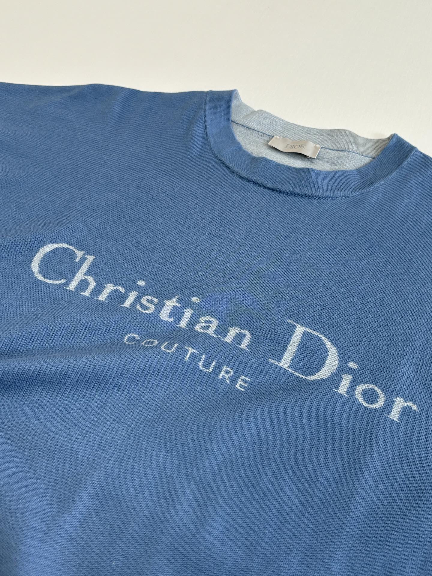Blue Christian Dior logo T-shirt chest print close-up