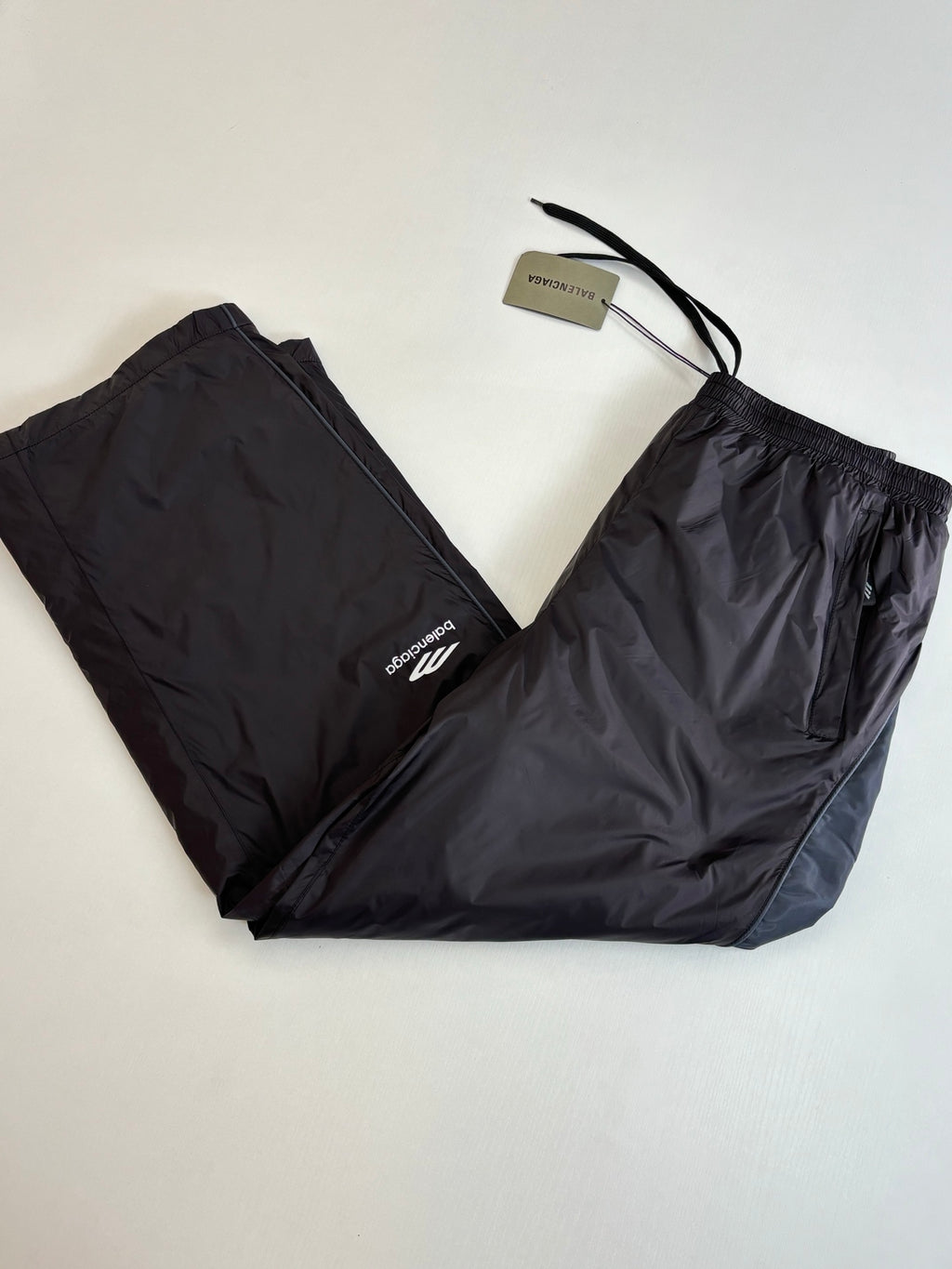 Balenciaga black nylon pants with drawstring tie and white logo on leg