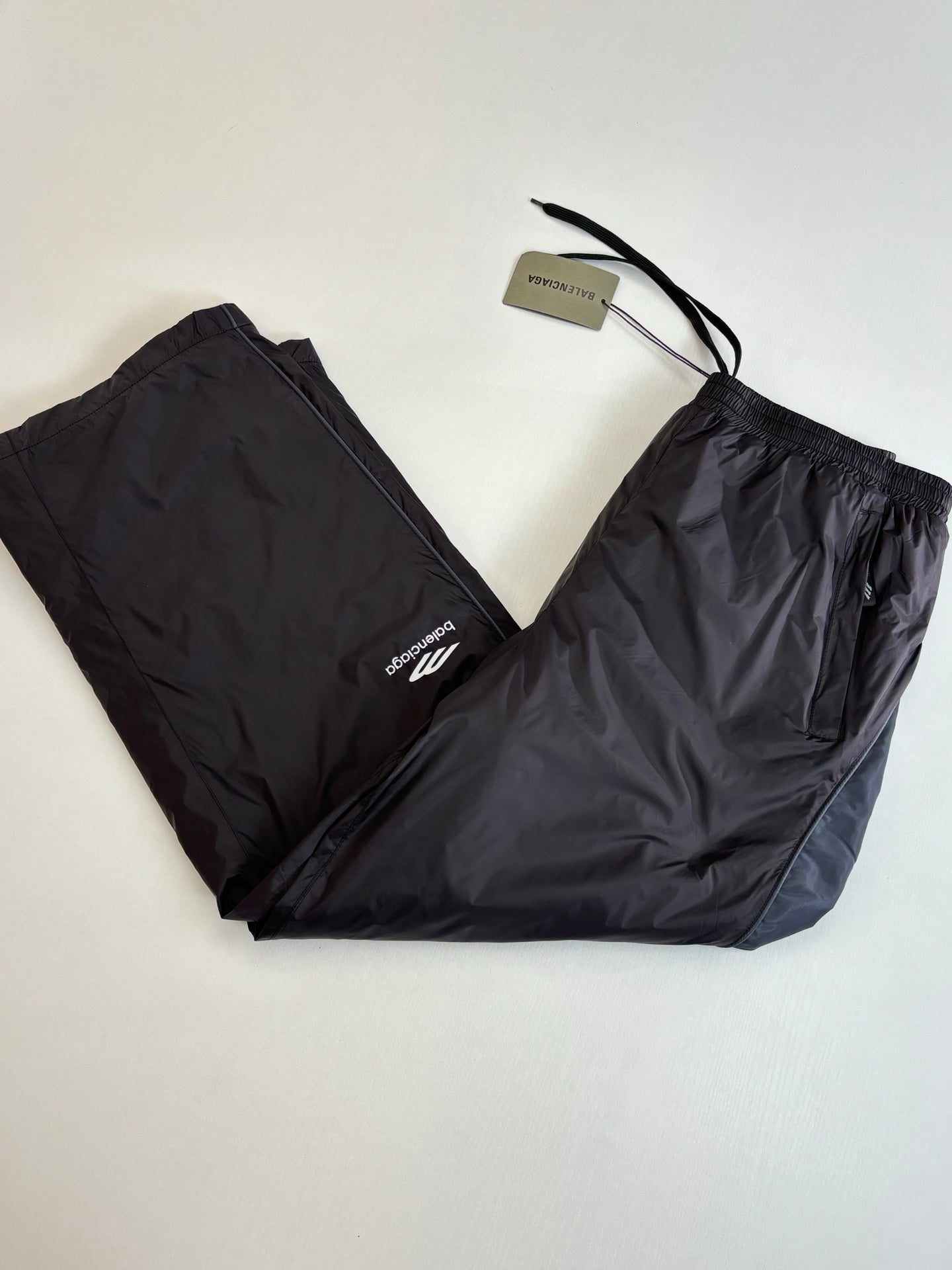 Balenciaga black nylon pants with drawstring tie and white logo on leg