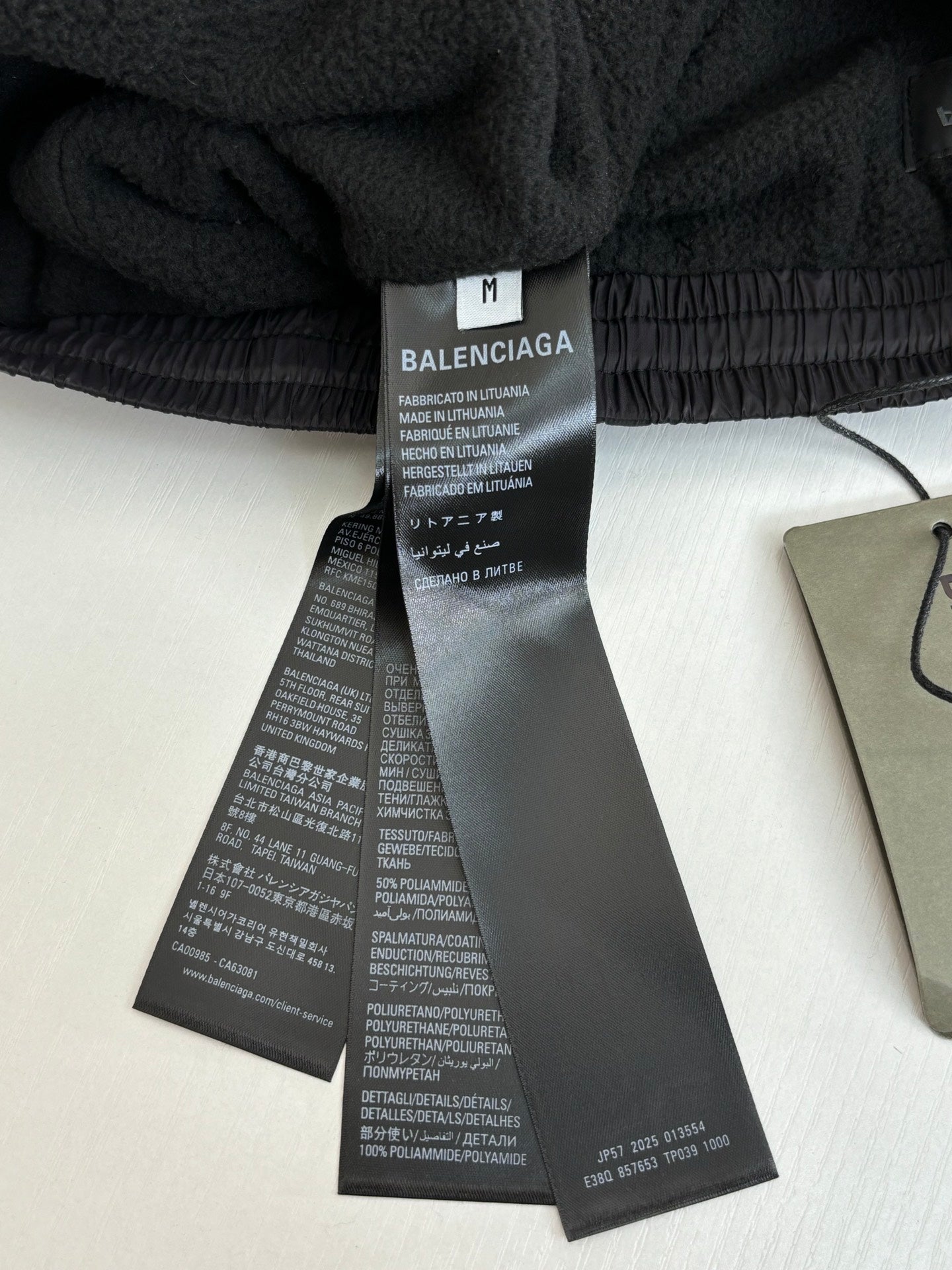 Balenciaga pants care and size tags on black elastic waistband