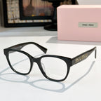 MiuMiu glasses with black frames and dark tinted lenses, front view