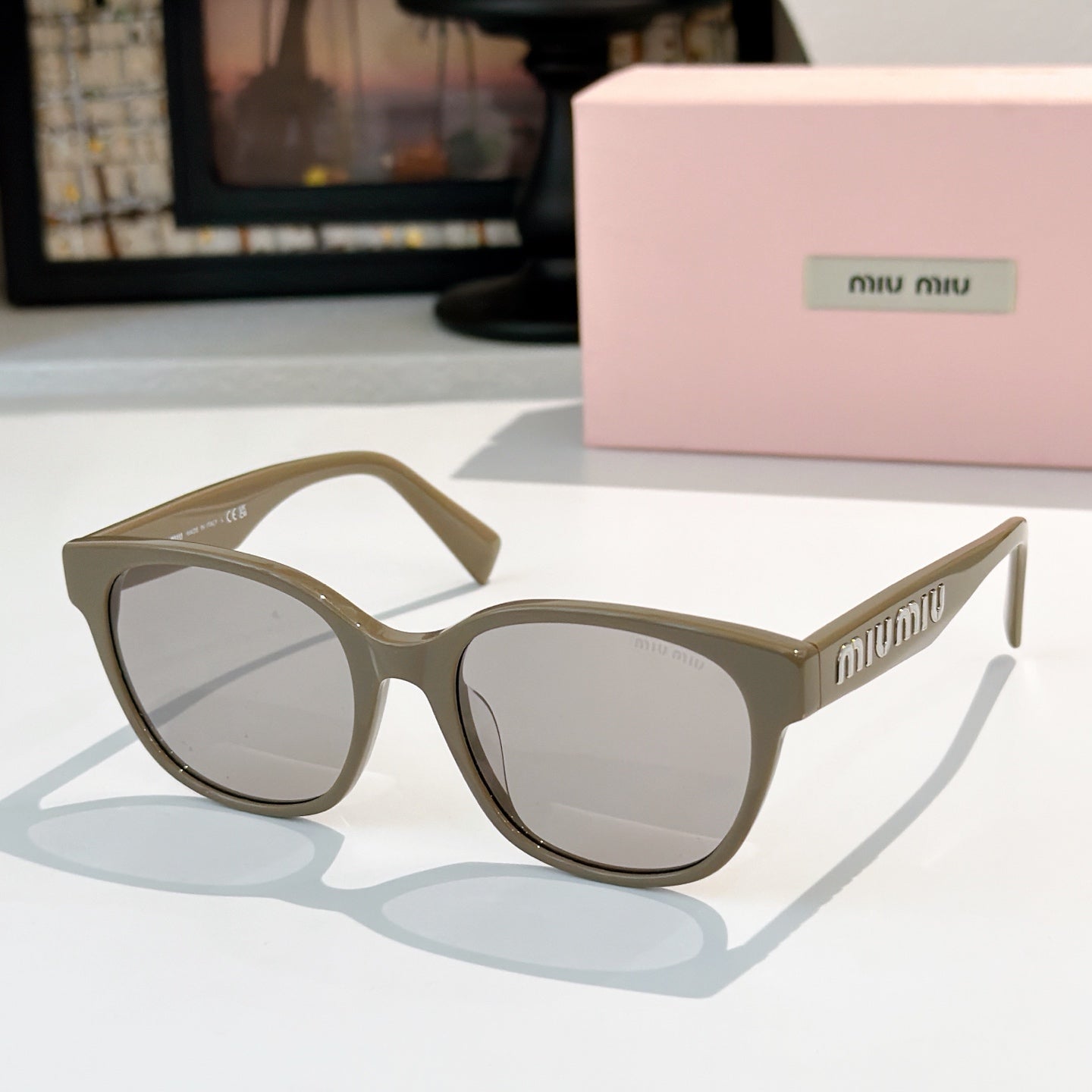 MiuMiu glasses with olive frames and clear lenses, front view