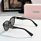 MiuMiu glasses with black frames and dark tinted lenses, side view