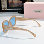 MiuMiu sunglasses with tan frames and blue lenses, side view showing curved arms.