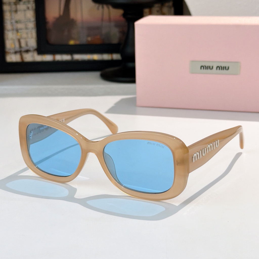 MiuMiu sunglasses with tan frames and blue gradient lenses, cat-eye style.