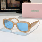MiuMiu sunglasses with tan frames and blue gradient lenses, cat-eye style.