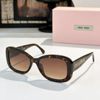 MiuMiu sunglasses with dark tortoise frames and brown gradient lenses, cat-eye.