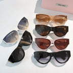 Set of MiuMiu cat-eye sunglasses with mixed frames and tinted lenses on display