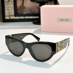 MiuMiu cat-eye sunglasses with black frames and smoky gray tinted lenses