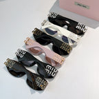 Assorted Miu Miu sunglasses set with black, white, and blush frames