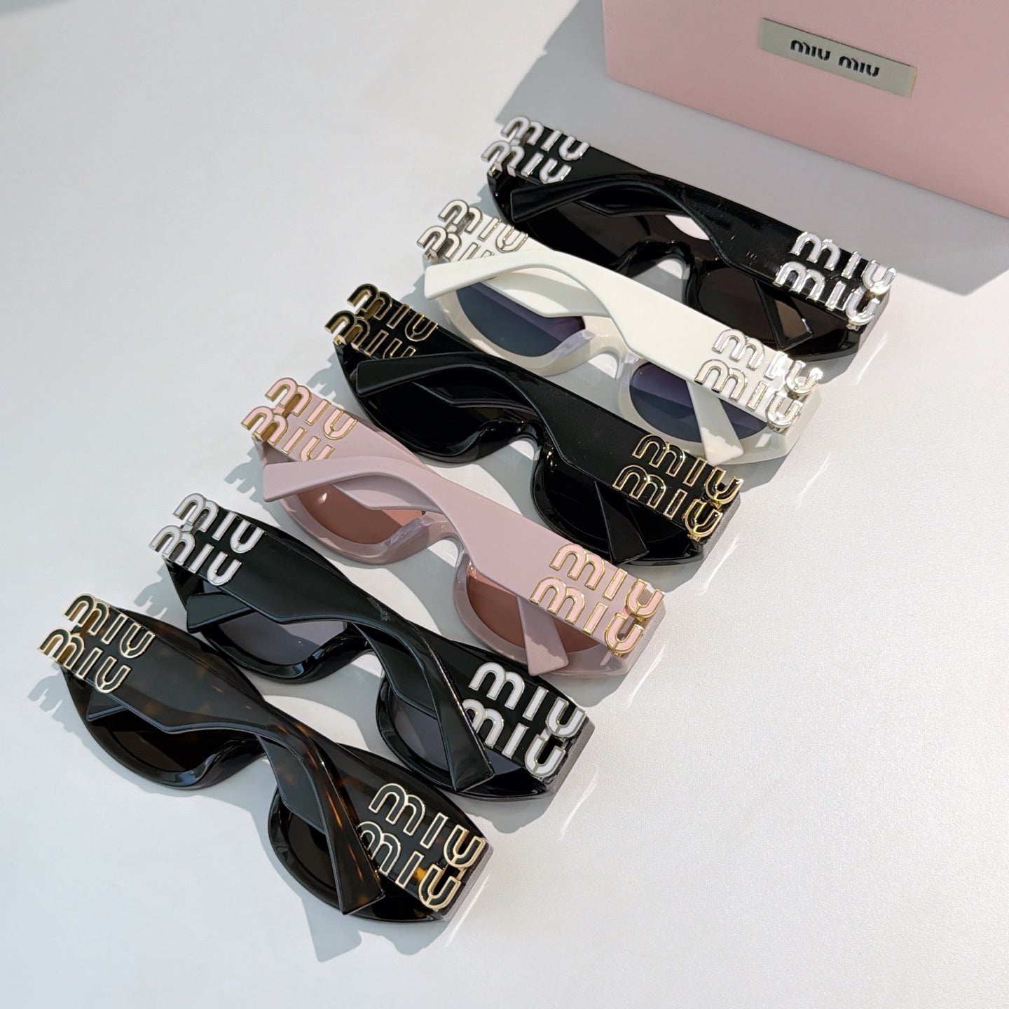 Assorted Miu Miu sunglasses set with black, white, and blush frames