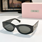 Black sunglasses with dark lenses and gold Miu Miu logo on the temples