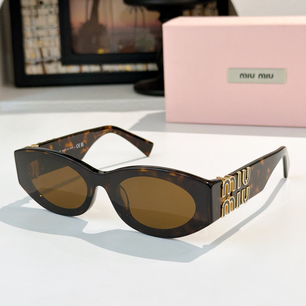 Tortoiseshell sunglasses with amber-brown lenses and gold Miu Miu logo on the temples
