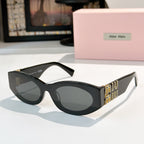 Black sunglasses with dark lenses and gold Miu Miu logo on the temples