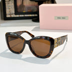 MiuMiu cat-eye sunglasses with tortoiseshell frames and brown tinted lenses, gold logo arms