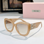 MiuMiu cat-eye sunglasses with beige frames and amber tinted lenses, gold logo arms