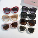 MiuMiu sunglasses assortment with red, beige, lavender, black and white frames, tinted lenses