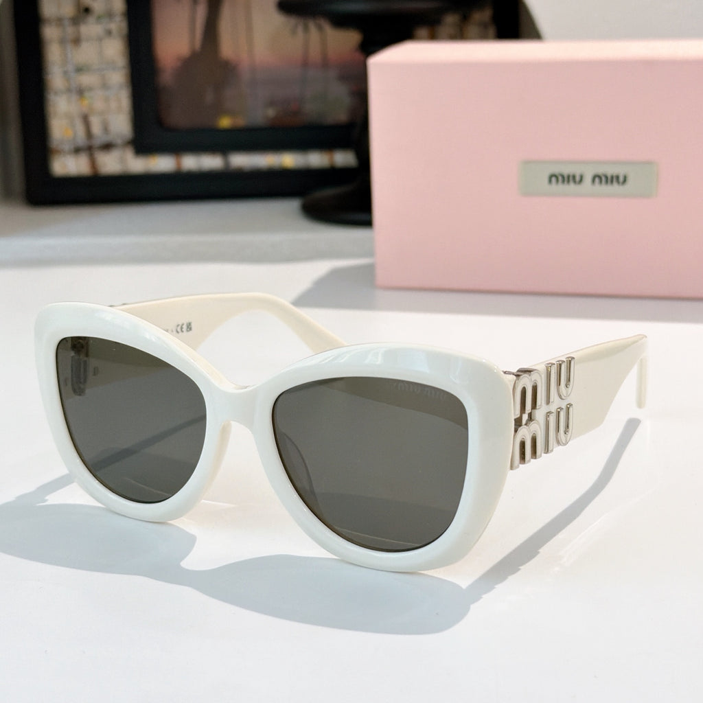 MiuMiu cat-eye sunglasses with white frames and dark gray tinted lenses, gold logo arms
