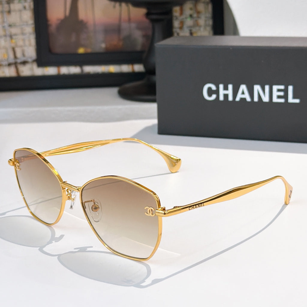 Gold-rim sunglasses with clear lenses and curved cat-eye frames