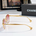 Gold metal sunglasses with pink lenses and cat-eye shape