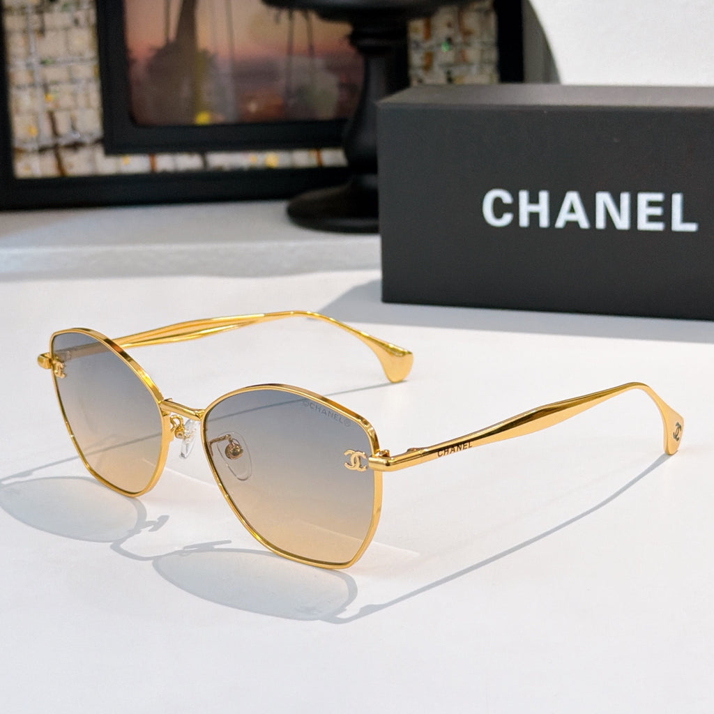 Gold-rim cat-eye sunglasses with gradient amber lenses and slim metal arms