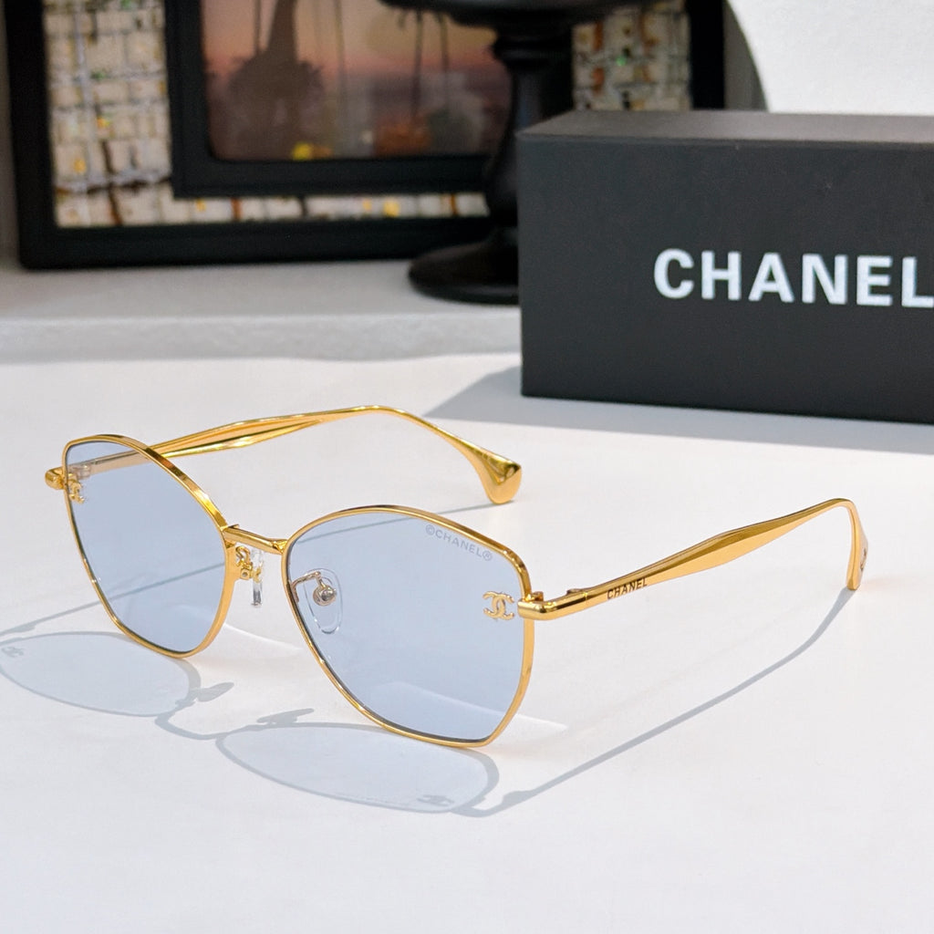 Gold-rim cat-eye sunglasses with light blue-tinted lenses and slim arms