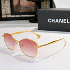 Gold-rim cat-eye sunglasses with pink tinted lenses and slim metal arms